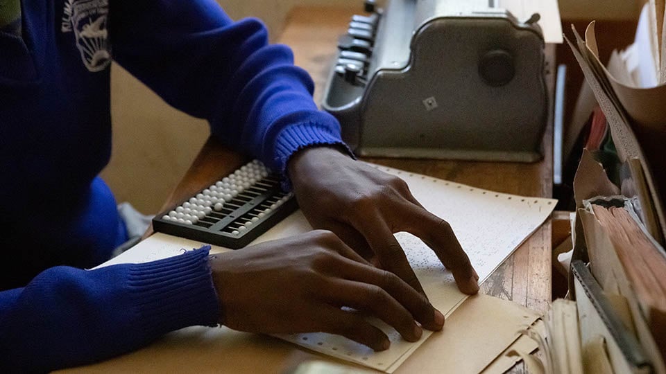 A student using a brailler to take a test.